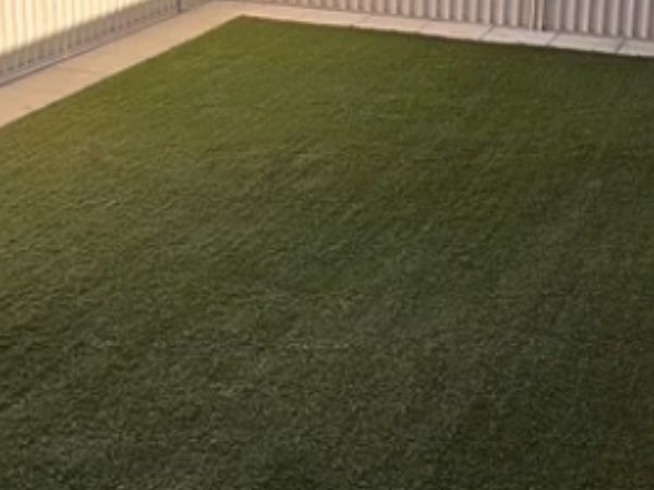 Same artificial turf after the 4-stage clean, debris cleared and fibres upright