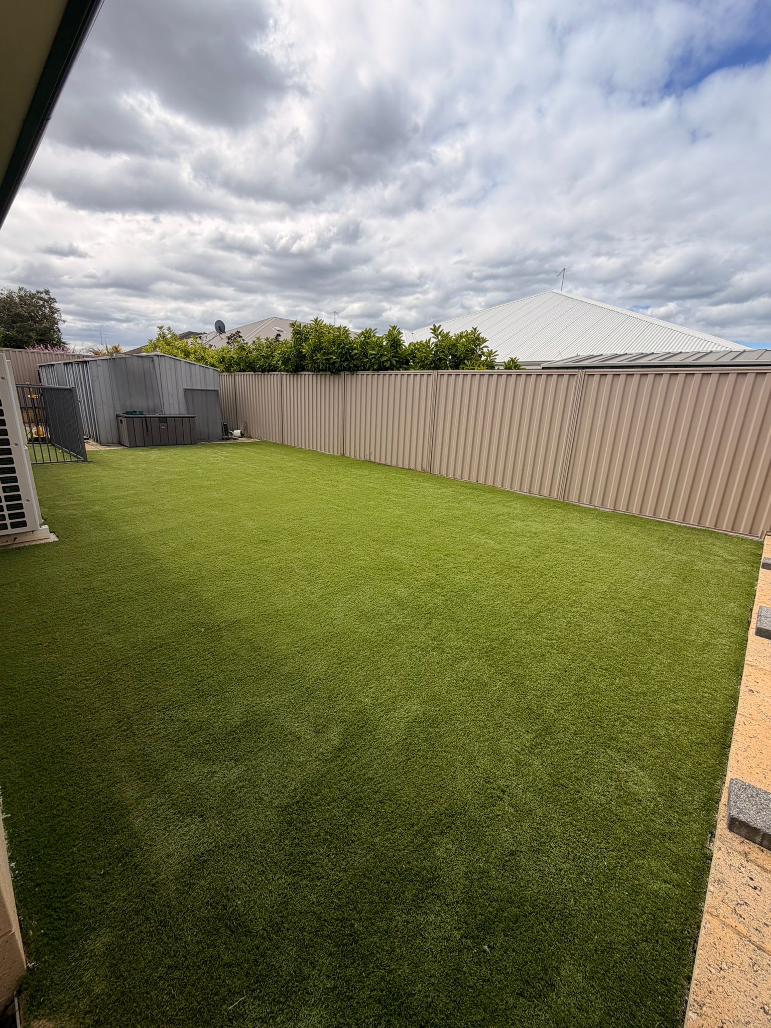 The same Beeliar backyard lawn after the 4-stage clean, pile lifted and colour brought back to an even vivid green